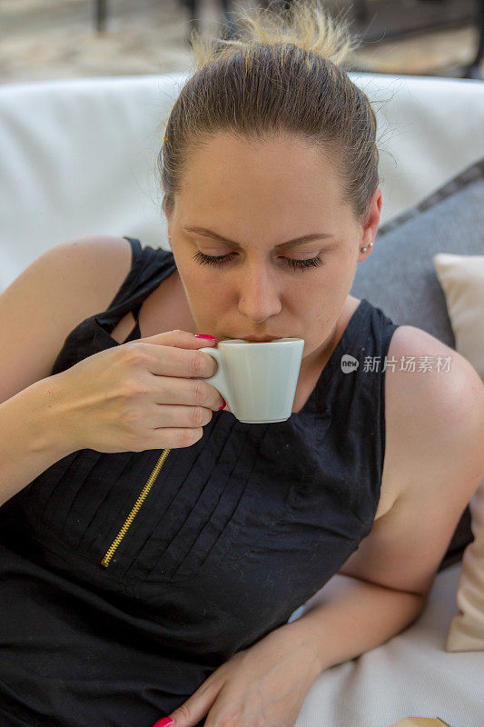 Woman enjoying cappuccino in a café